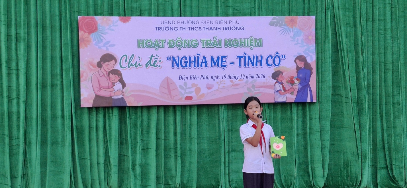 'A person standing in front of a banner

Description automatically generated'
